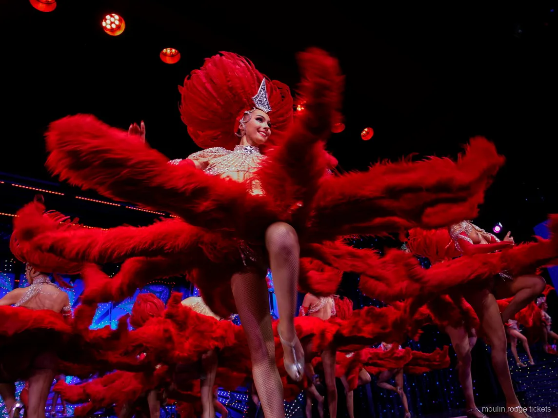 Danseressen zwaaien met grote rode verenwaaiers bij een hoge trap, Moulin Rouge dinner show kaarten
