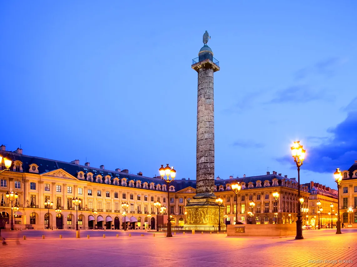 Place Vendôme at dusk with its tall column and glowing street lamps, a stop on the tour with Moulin Rouge tickets