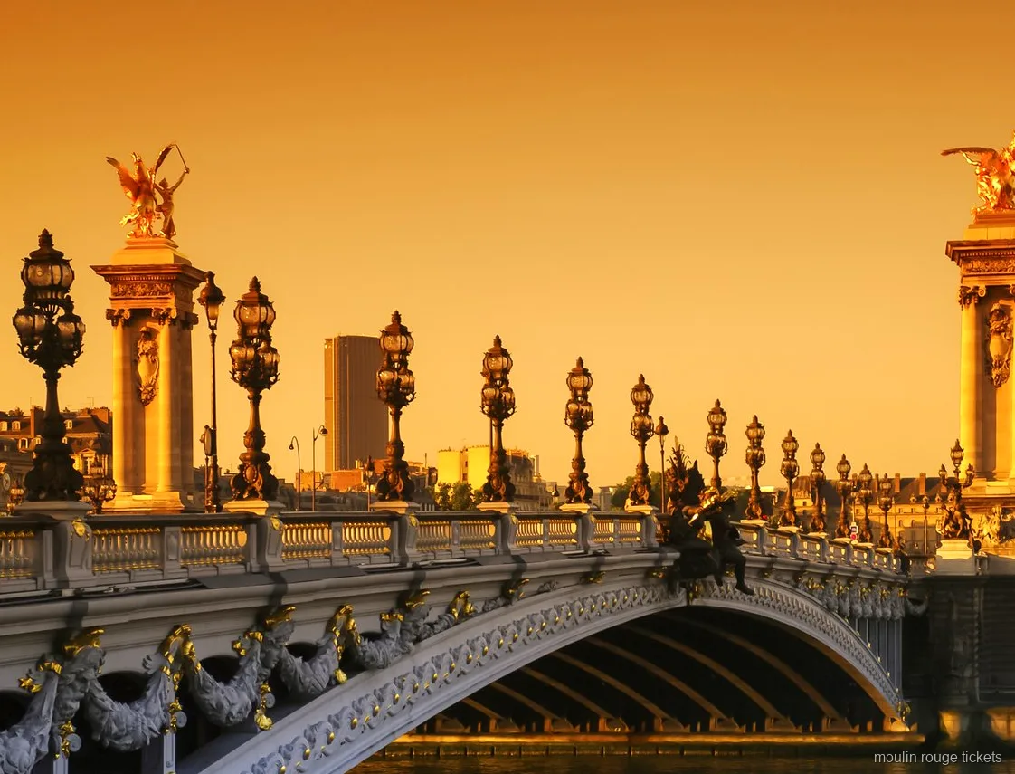 Pont Alexandre III with gilded statues and ornate lamps at sunset, a sight on the Paris tour with Moulin Rouge tickets